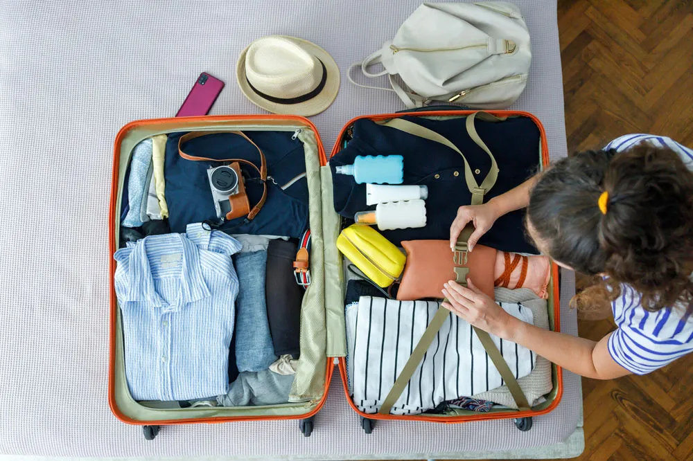 flat-lay-of-travel-essentials-with-temple-appropriate-clothing-sunscreen-and-insect-spray flat-lay-of-travel-essentials-with-temple-appropriate-clothing-sunscreen-and-insect-spray